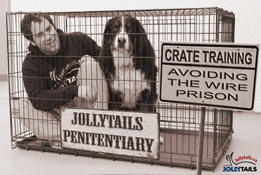 A Jollytails trainer and dog posing inside a crate beside humorous signs warning against making a crate feel like a wire prison