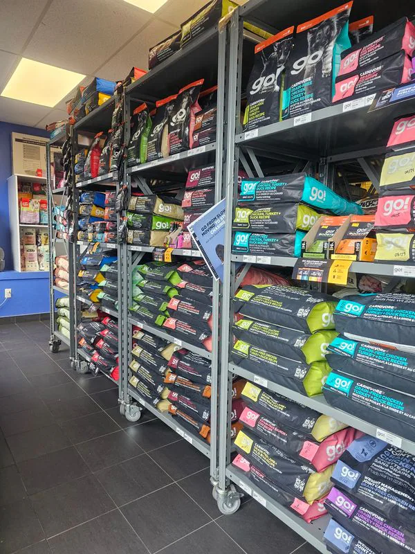 Shelves stocked with colourful bags of dog food at Jollytails