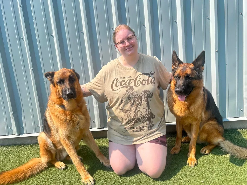 Autumn from the Jollytails Burnside daycare team with two dogs