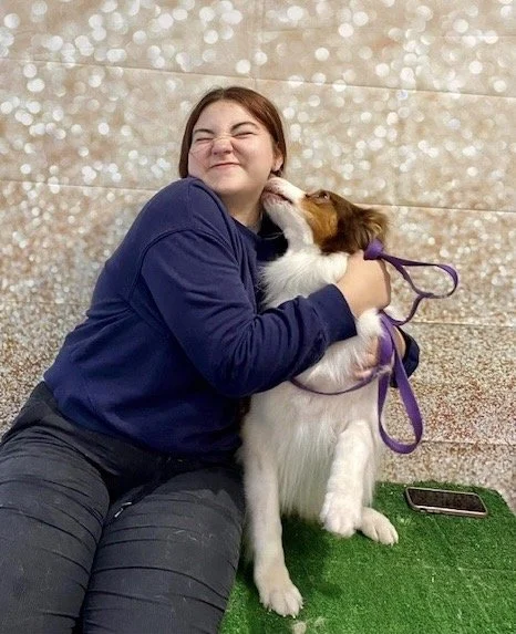 Janika, a Jollytails Dartmouth groomer, with a dog
