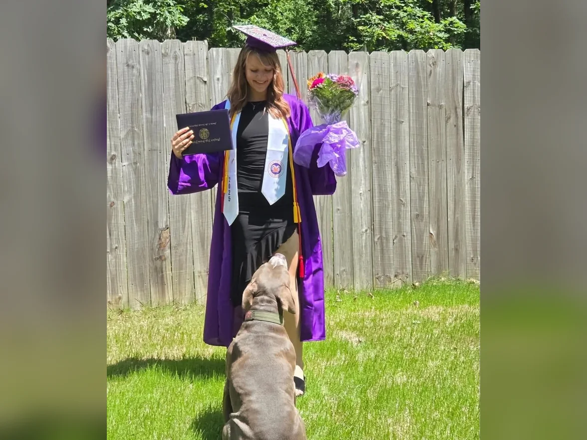 Laney from the Jollytails Burnside daycare team with their dog, Hank