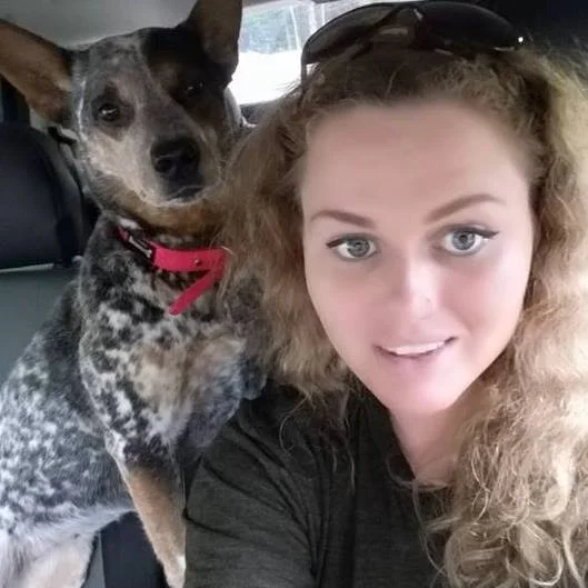 Angie, a Jollytails groomer, with a dog
