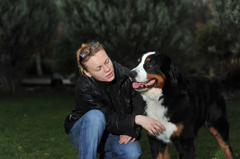 Oksana, a Jollytails groomer, with a dog